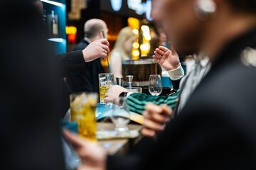 Crafting exquisite cocktails at an upscale bar during a lively evening gathering