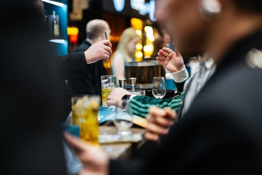 Crafting exquisite cocktails at an upscale bar during a lively evening gathering