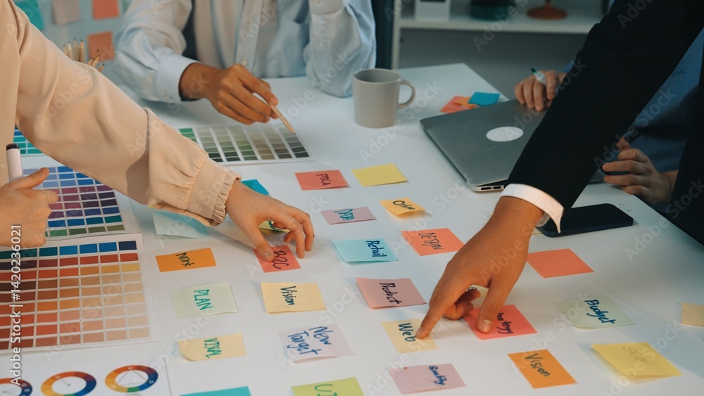 Poster a group of diverse professionals engages in a productive brainstorming session utilizing sticky note