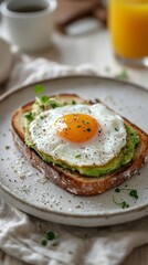 A plate of toast with an egg and avocado on top