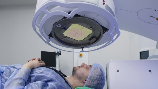 A young man undergoes radiation therapy for cancer at a state-of-the-art ocncology center. Concepcion of medical technology and theropy for cancer patients.