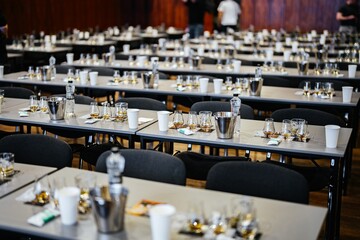 Tables set for a grand tasting event at a rustic venue