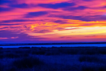 The sunset sky, the colors of the sun setting over the horizon on the clouds