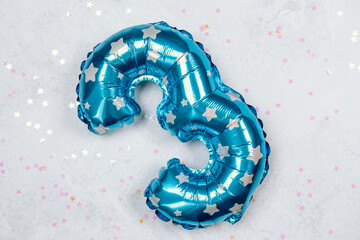 Colorful blue number three balloon with silver stars on a festive background