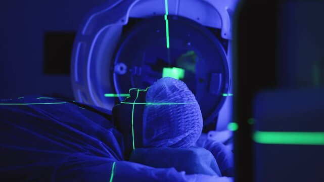 A young man undergoing radiation therapy for cancer in a state-of-the-art oncology clinic using a linear accelerator. The concept of modern approaches to oncology treatment.