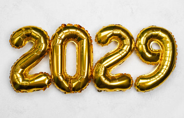 Celebration decorations featuring golden balloons with the number 2029 displayed