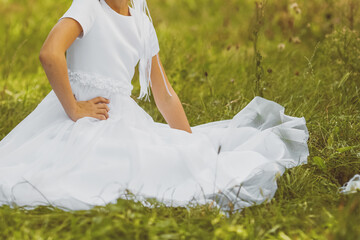 Young girl posing in white First Communion dress symbolizing purity faith and sacred Christian...