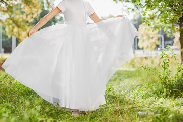Young girl posing in white First Communion dress symbolizing purity faith and sacred Christian...