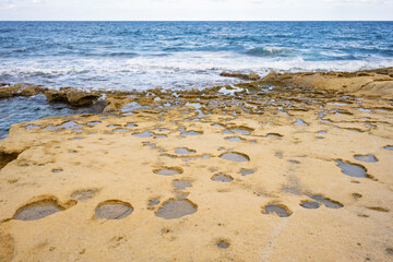 Sandstone bedrock, patterns of cracks and fissures, Malta. Secluded bays and beautiful coastline in Malta	
