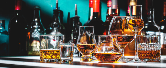 Strong hard alcoholic drinks, spirits, liqueurs, distillates, whiskey and others in glasses and...