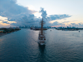 Sailing boat at dramatic sky seascape. Ship sailing the sea. Sail oat at port Miami. Travel by sea. Seascape horizon at sunset. Sea vacation. Sailboat vessel. Travel destination. Sail training ship