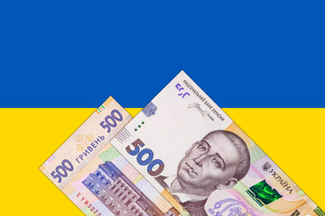 Ukrainian banknote 500 hryvnia on the background of the flag of Ukraine. Paper money of Ukraine.