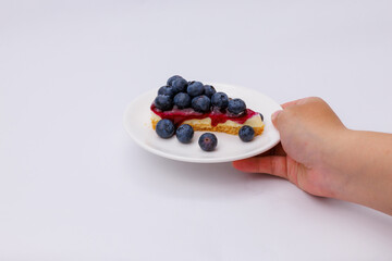 Start your morning right with a luscious blueberry sheet cake, crowned with fresh blueberries and served alongside rich black coffee.