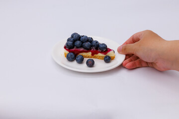 Start your morning right with a luscious blueberry sheet cake, crowned with fresh blueberries and served alongside rich black coffee.