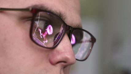 The doctor is reading the MRI scans. The glasses reflect the results. The concept of modern technology and accurate diagnosis.