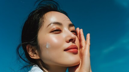 Woman applying sunscreen outdoors