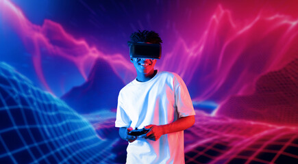Teenager holding joystick and wearing VR goggles while enjoy playing games at neon abstract...