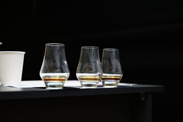 Whiskey tasting experience with elegant glasses on a black table