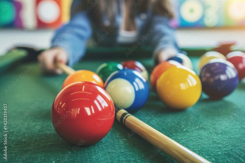 Poster a close-up of colorful billiard balls on a green pool table, with a player in the background prepari