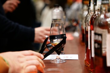 Tasting fine spirits at a local distillery event in the evening glow