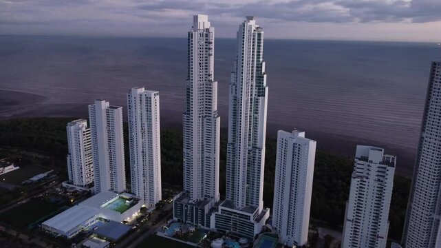 Aerial view from a drone in the Costa del Este neighborhood with the Panama City skyline over Panama City at sunset.