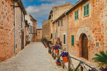 Valldemossa typical village with plants pots in facades at Mallorca island, Spain