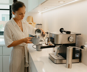 A couple is making coffee in the kitchen