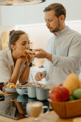 A couple having breakfast in the kitchen