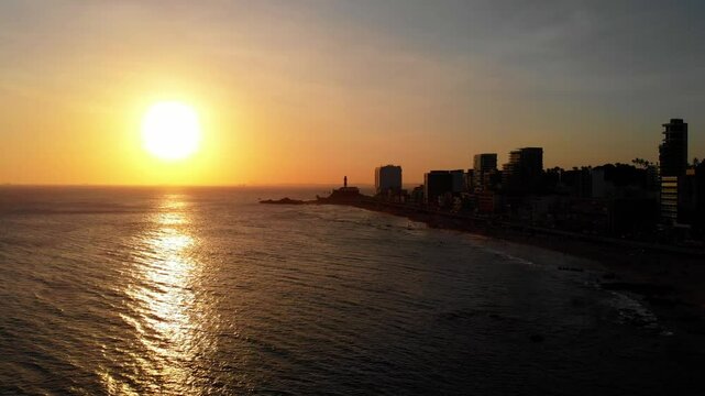 Sunset over Farol da&nbsp;Barra lighthouse, Salvador - orbital drone 4K
A dramatic  aerial orbit shot of the iconic Farol da Barra lighthouse and Salvador coastline at golden hour. 
