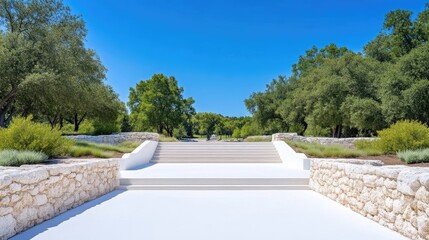 Grand stone steps leading into a lush park under a vibrant blue sky