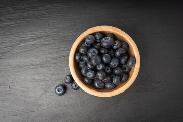 Blueberry on black plate. Fresh blue berry fruits, bilberry group on dark background