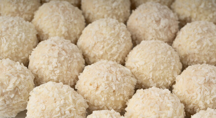 Coconut candies texture background, coco balls pattern. White truffle ball wallpaper, indian ladoo
