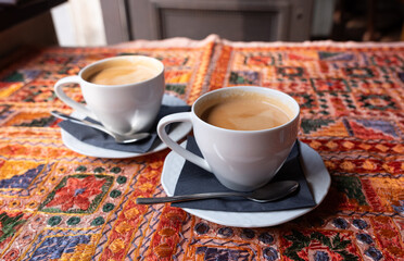 Masala chai an Indian restaurant, spiced milk tea, traditional cardamom hot drink with spices