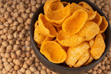 Hummus chickpea chips, chick pea crisps pile, healthy orange snack, fried legume crunchies