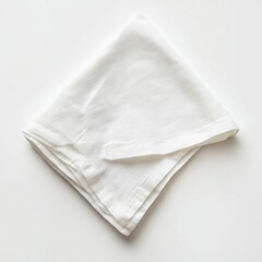 A folded white cloth napkin on a white surface in a square format shot
