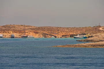 Papier peint photo intissé A beautiful blue ocean with a few boats in the water