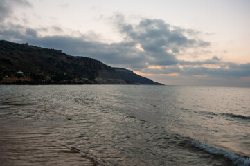 The ocean is calm and the sky is cloudy