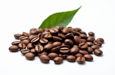 Fototapeta premium Heap roasted coffee beans with green leaf on white background. Macro shot, close-up of brown grains, cafe aroma, fresh coffee, morning drink, energy concept, breakfast. Ideal for cafe design product