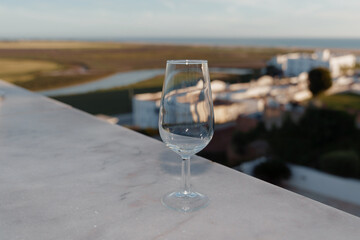 Cup of wine with an unfocused background of the town of Conil de la Frontera