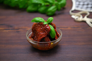 dried tomatoes in a glass bowl on the table close-up