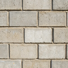 Fototapeta premium Generative AI illustration of a a close-up view of a concrete block wall, featuring rectangular blocks arranged in a regular, grid-like pattern. 