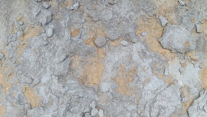 stone wall texture, close-up of a rough, textured surface with shades of gray and brown. Natural and raw stone or concrete texture