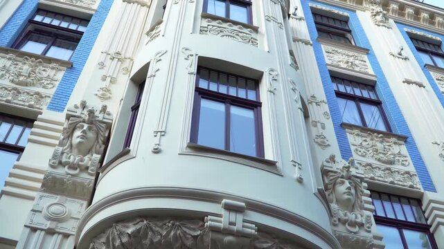 The famous Art Nouveau architecture sample in Europe, the building facade with sculpture and decorative element details on Alberta Street, Riga (Latvia), in a low-angle panoramic view.