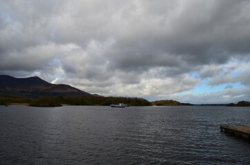 Dark Clouds and Mountains Over Body of Water