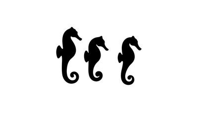 Fototapeta premium Three Black Silhouetted Seahorses Against White Background 