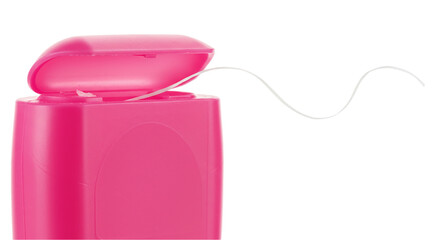 Close up of a pink dental floss container with floss coming out against a black background