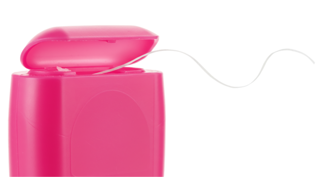 Close up of a pink dental floss container with floss coming out against a black background