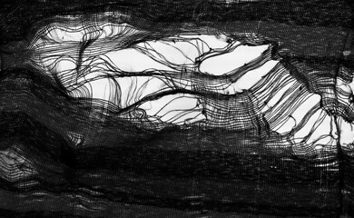 hanging teared rag spread isolated on black background , can use like a background or any texture....