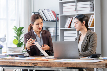 Businesswomen Discussing Financial Report in Office