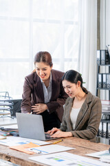 Two Businesswomen Collaborating on Laptop
